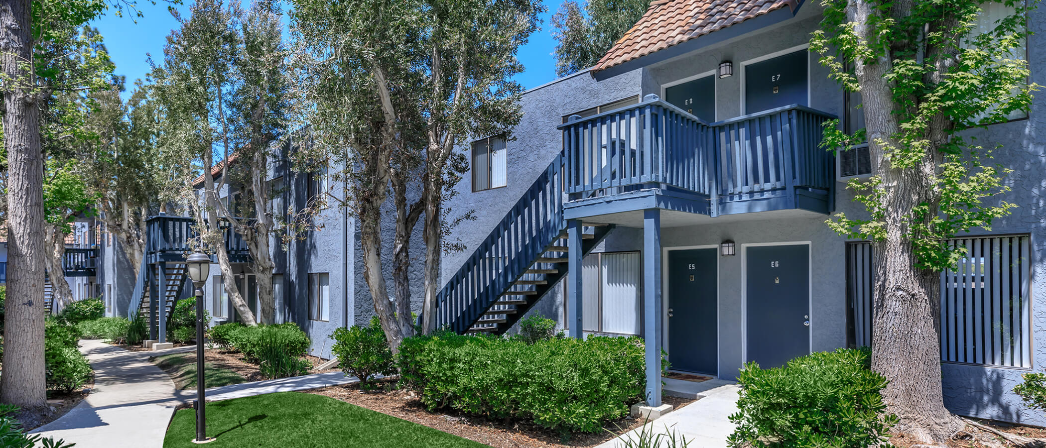 Outside of apartment building with lush landscaping